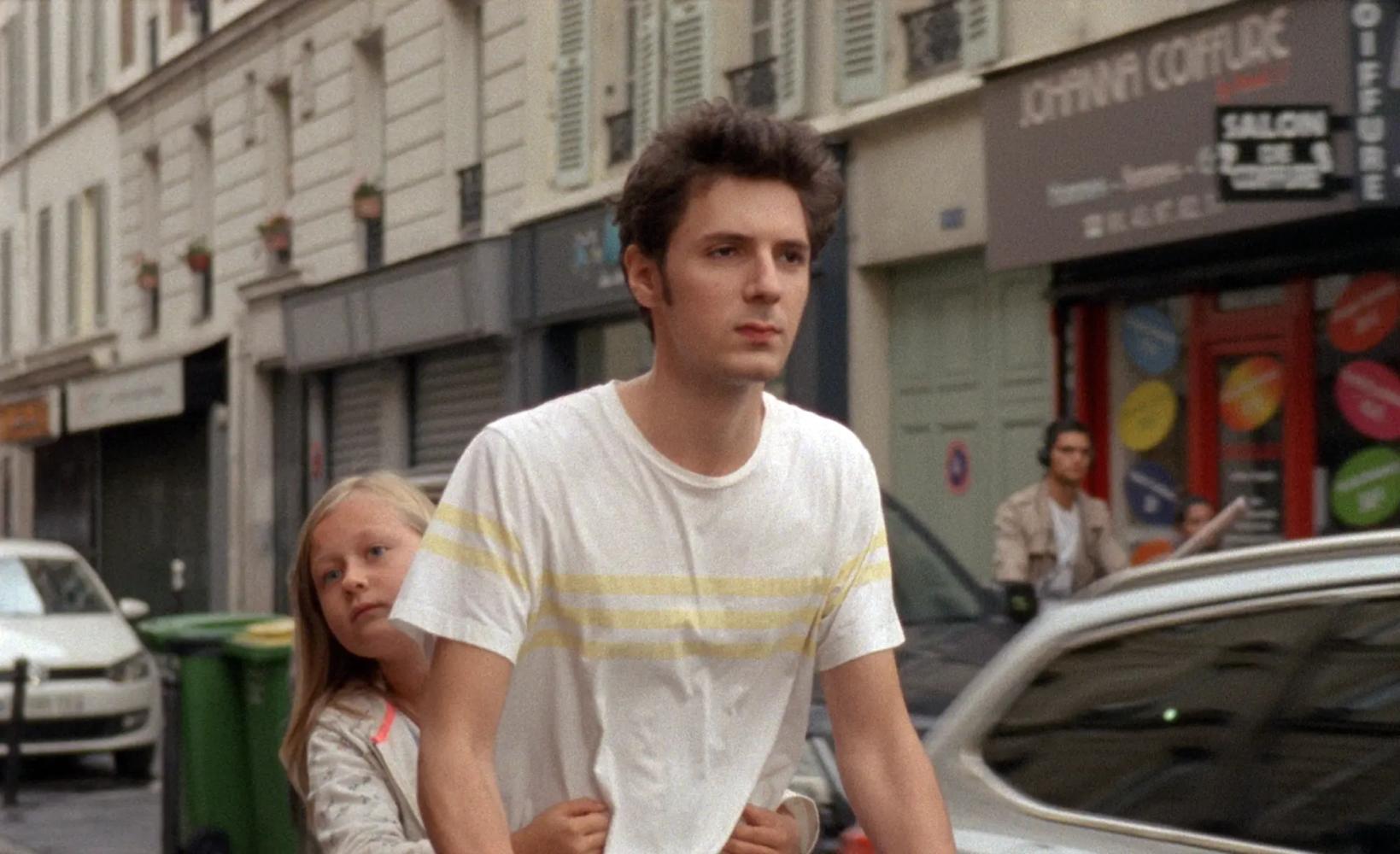 Vincent Lacoste et al. standing in front of a building