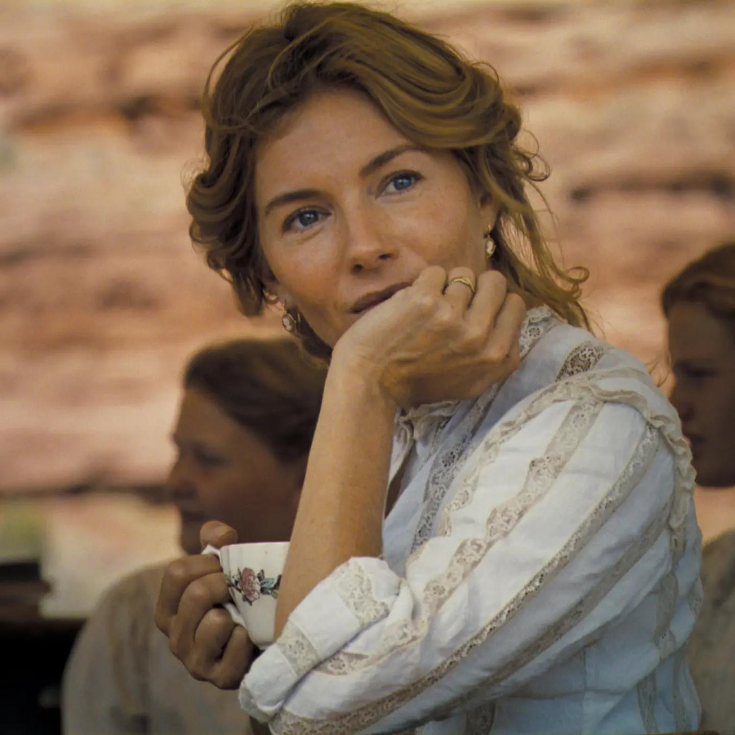 Sienna Miller holding a cup