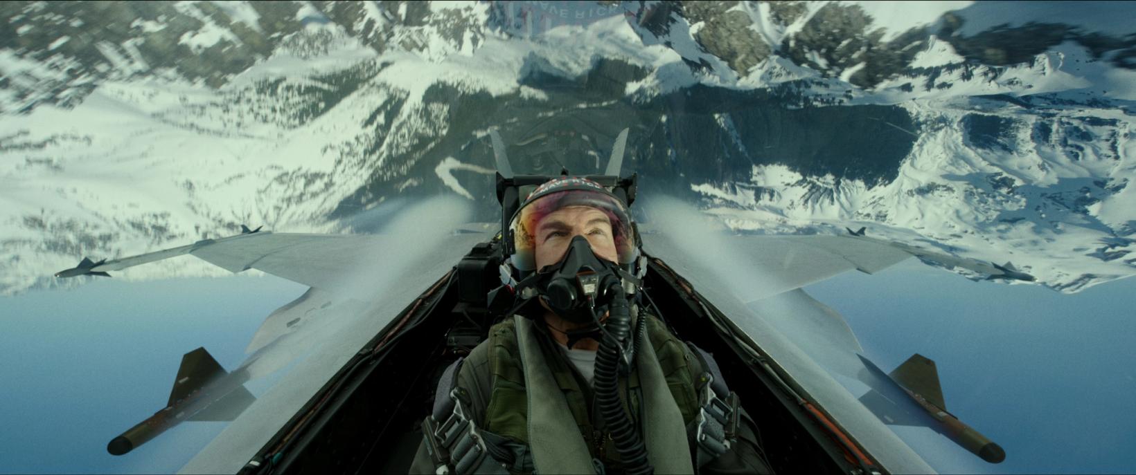 a man in a helmet and goggles on a snowy mountain