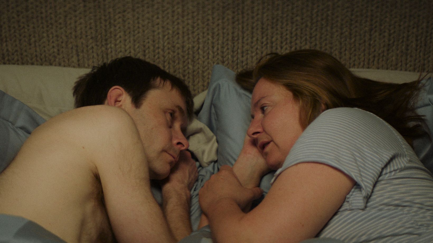 a man and woman lying on a couch