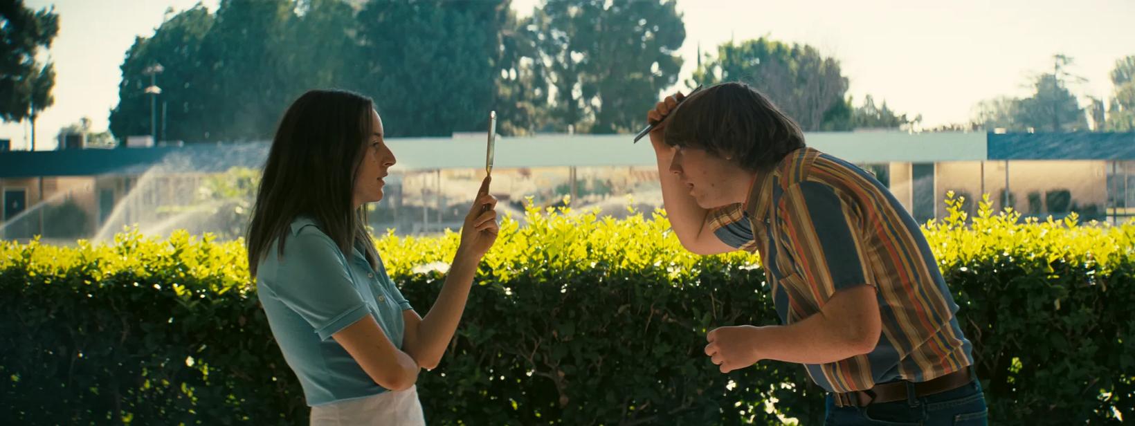 a man and woman holding a stick
