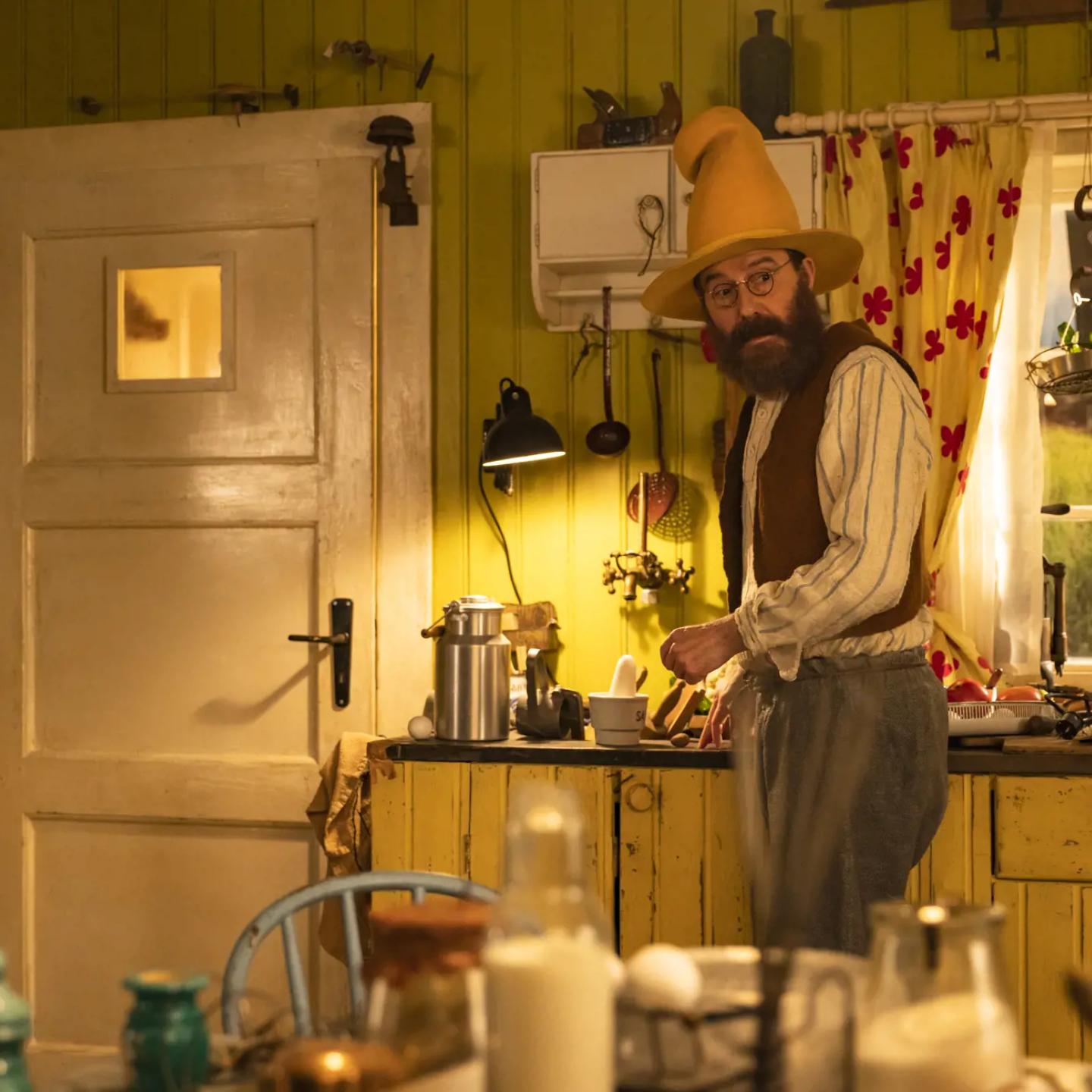 a person in a cowboy hat cooking in a kitchen