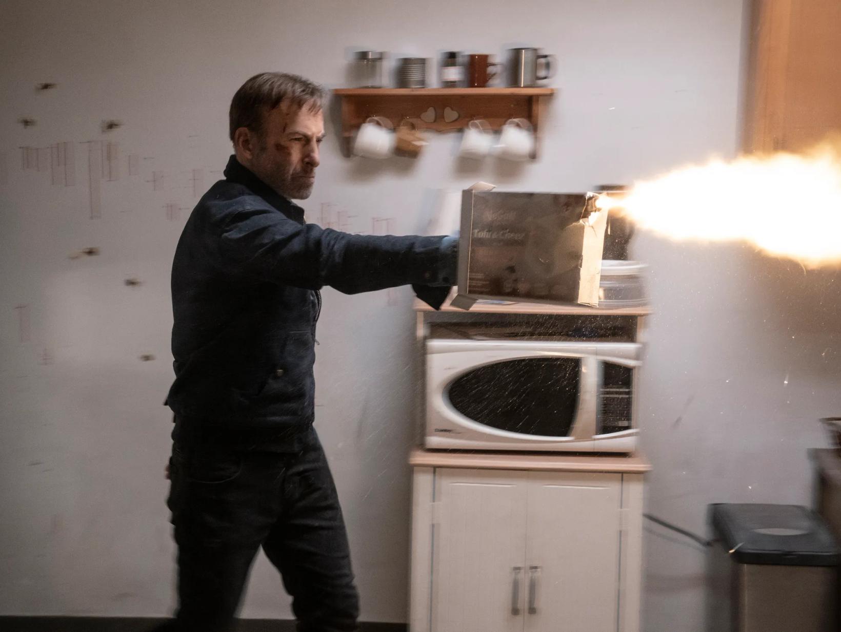 a man opening a toaster oven