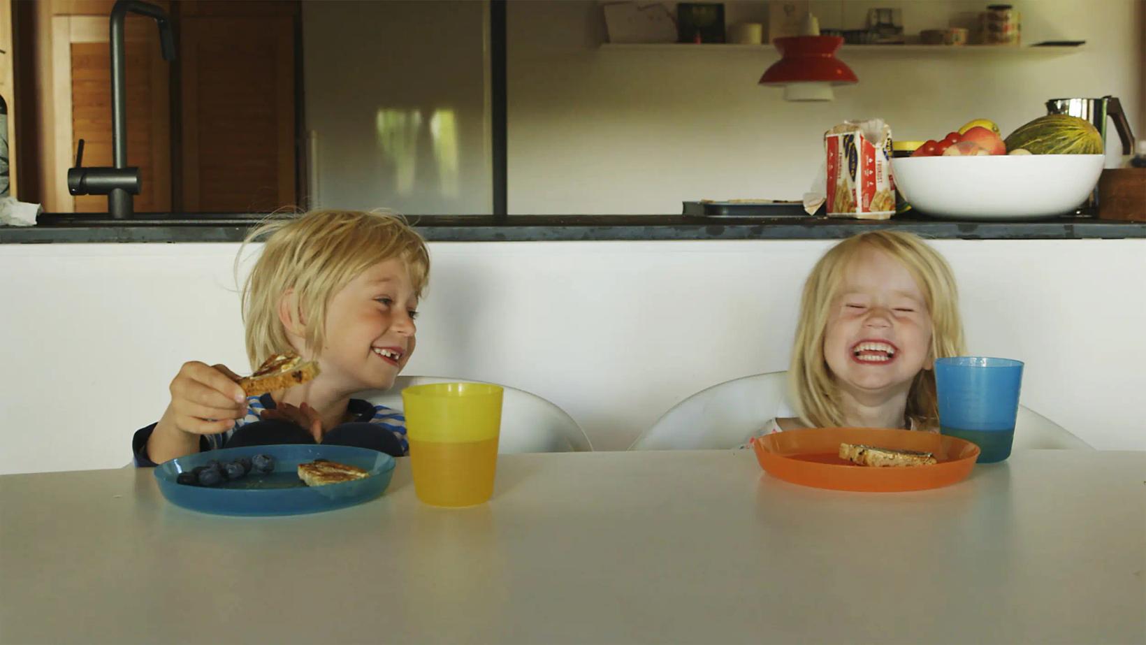two children eating at a table