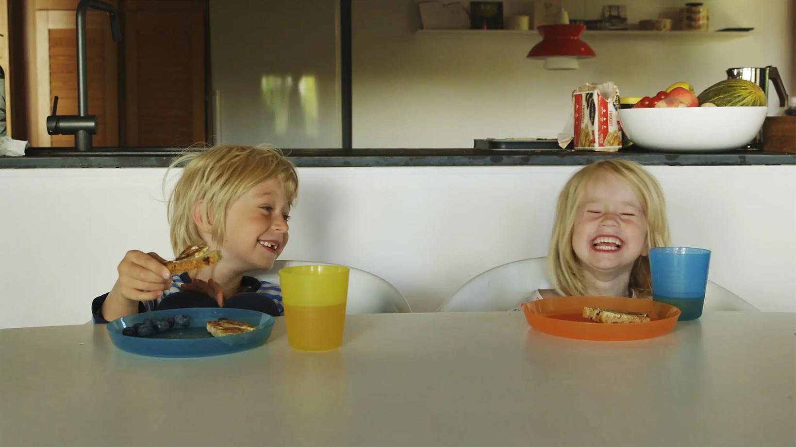 two children eating at a table