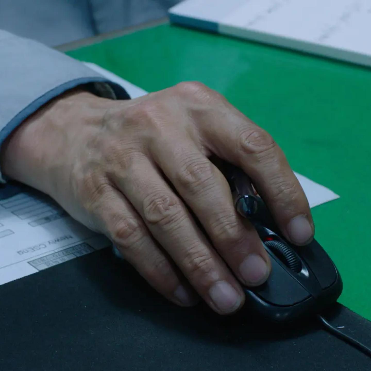 a person's hand on a mouse