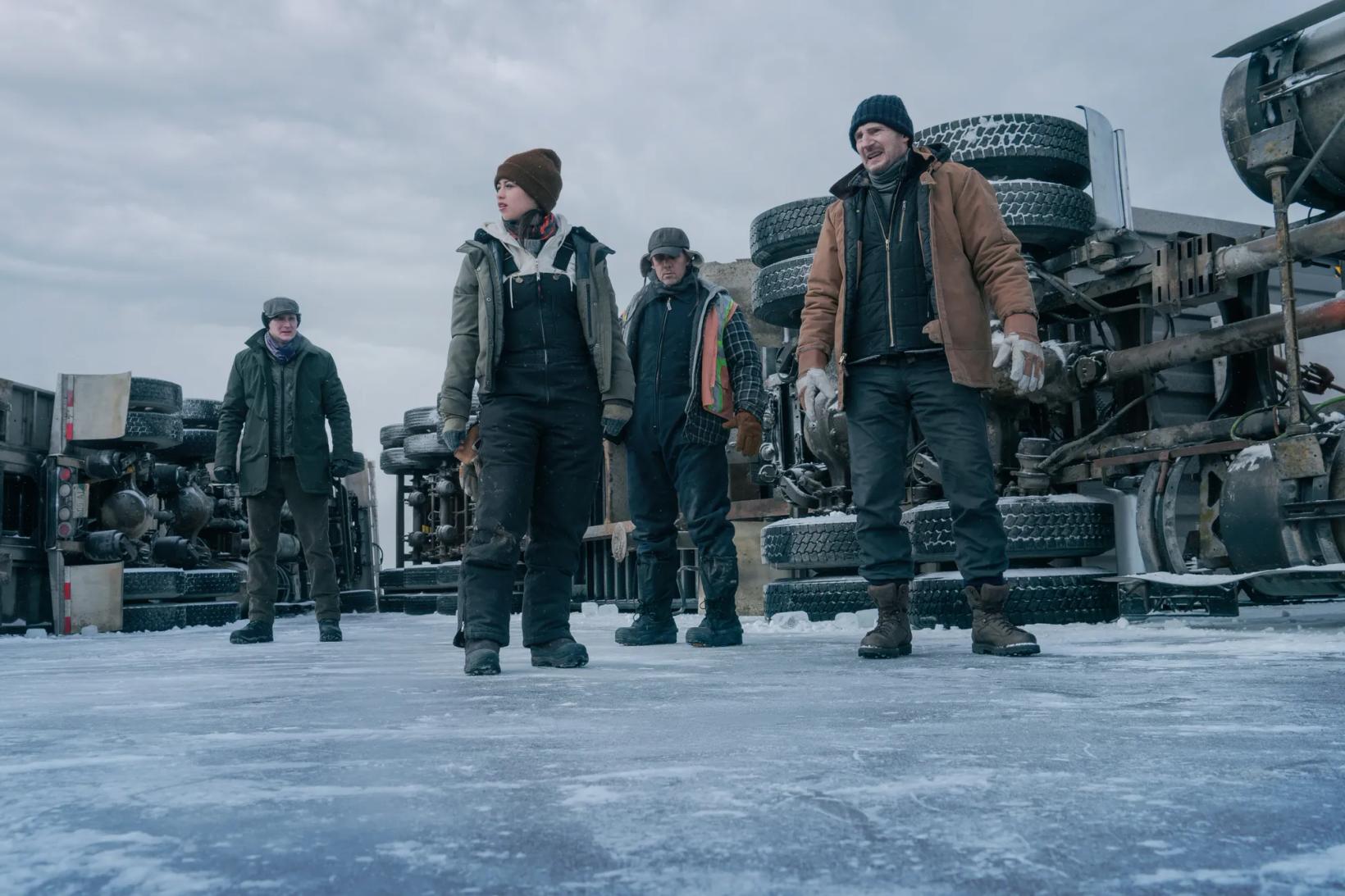 a group of men standing in the snow