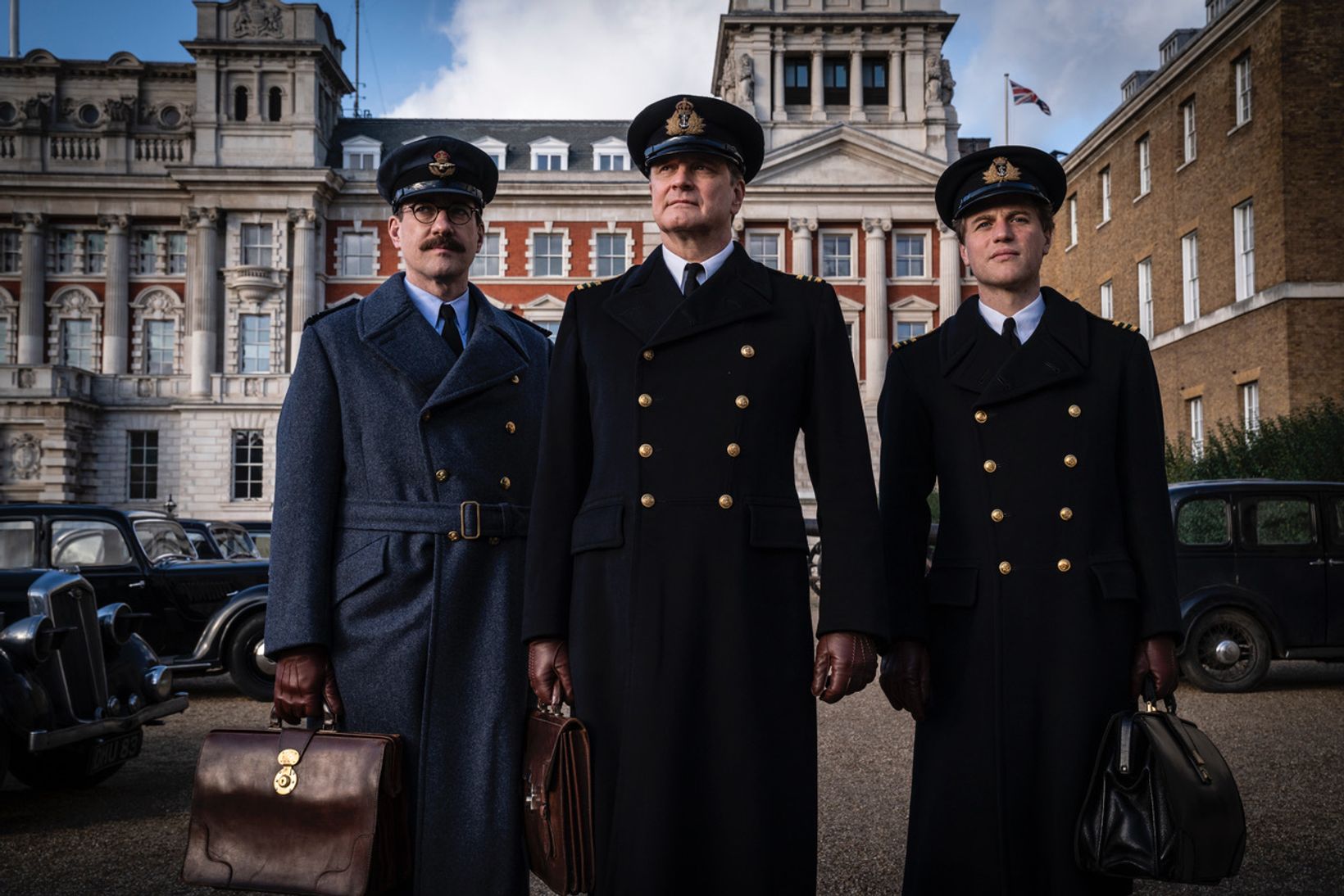 Colin Firth, Johnny Flynn et al. are posing for a picture