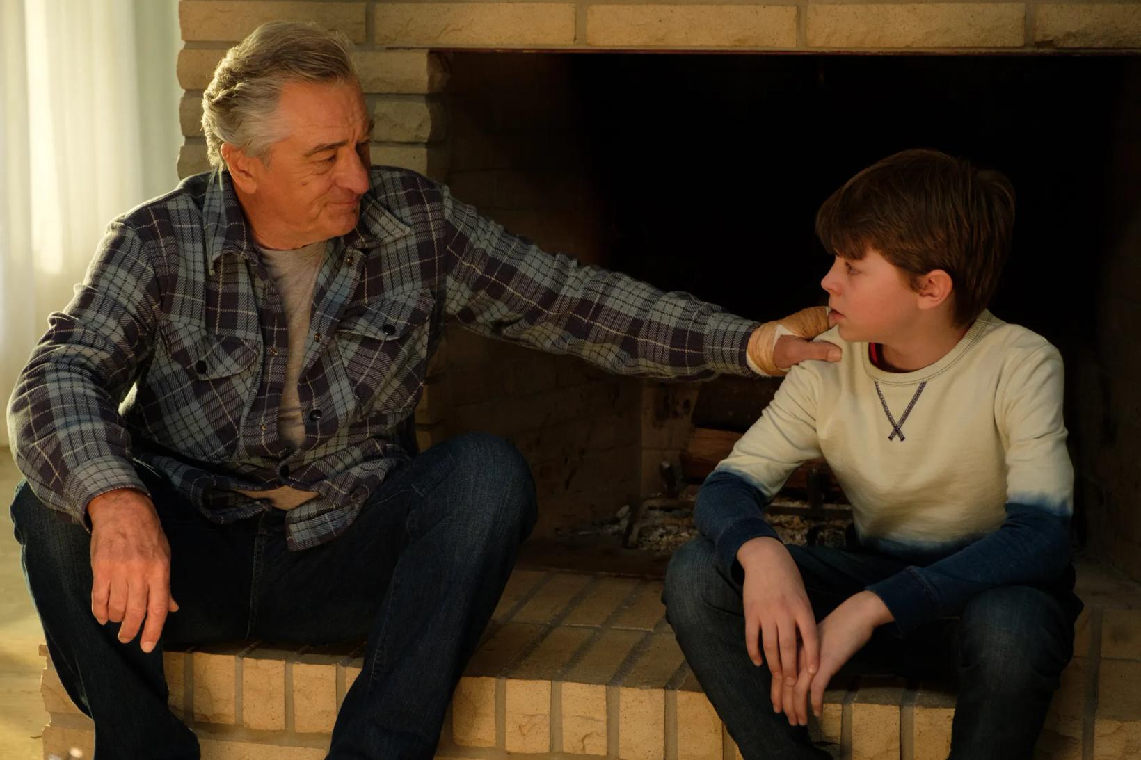 Robert De Niro and a boy sitting on a bench