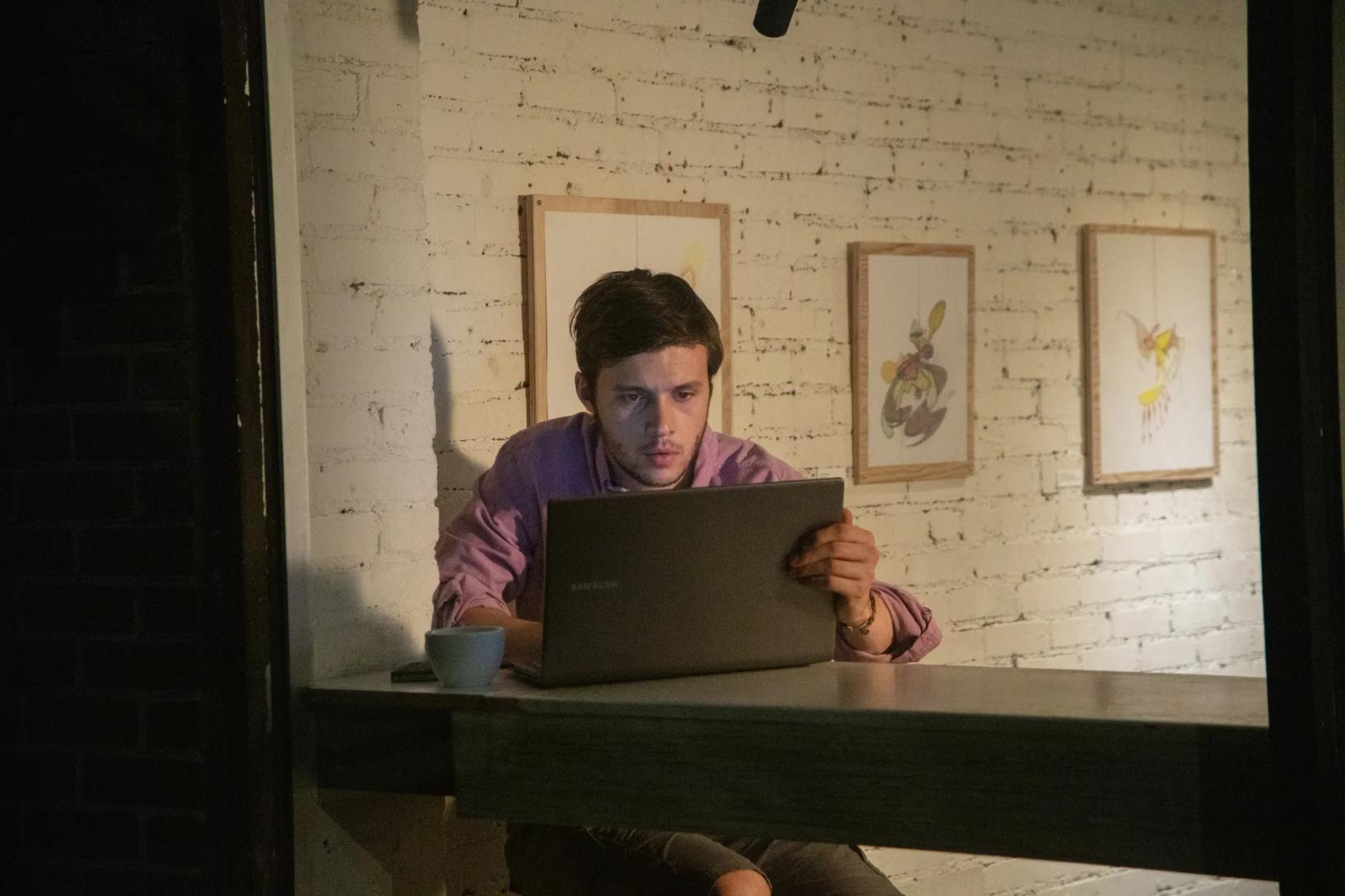 Nick Robinson sitting at a table with a laptop