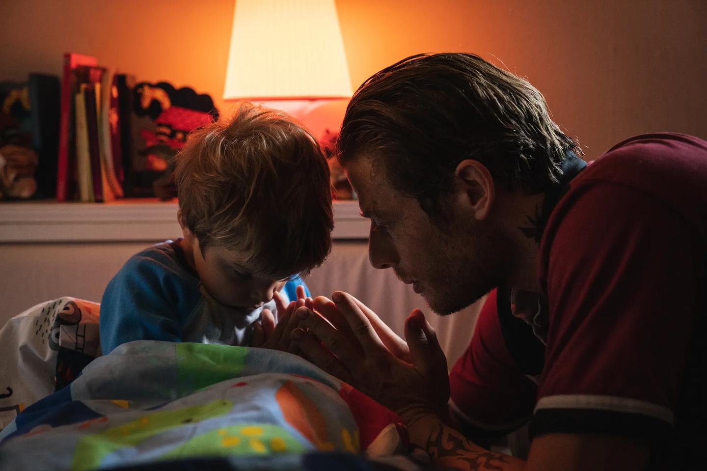 a man and a child looking at a book