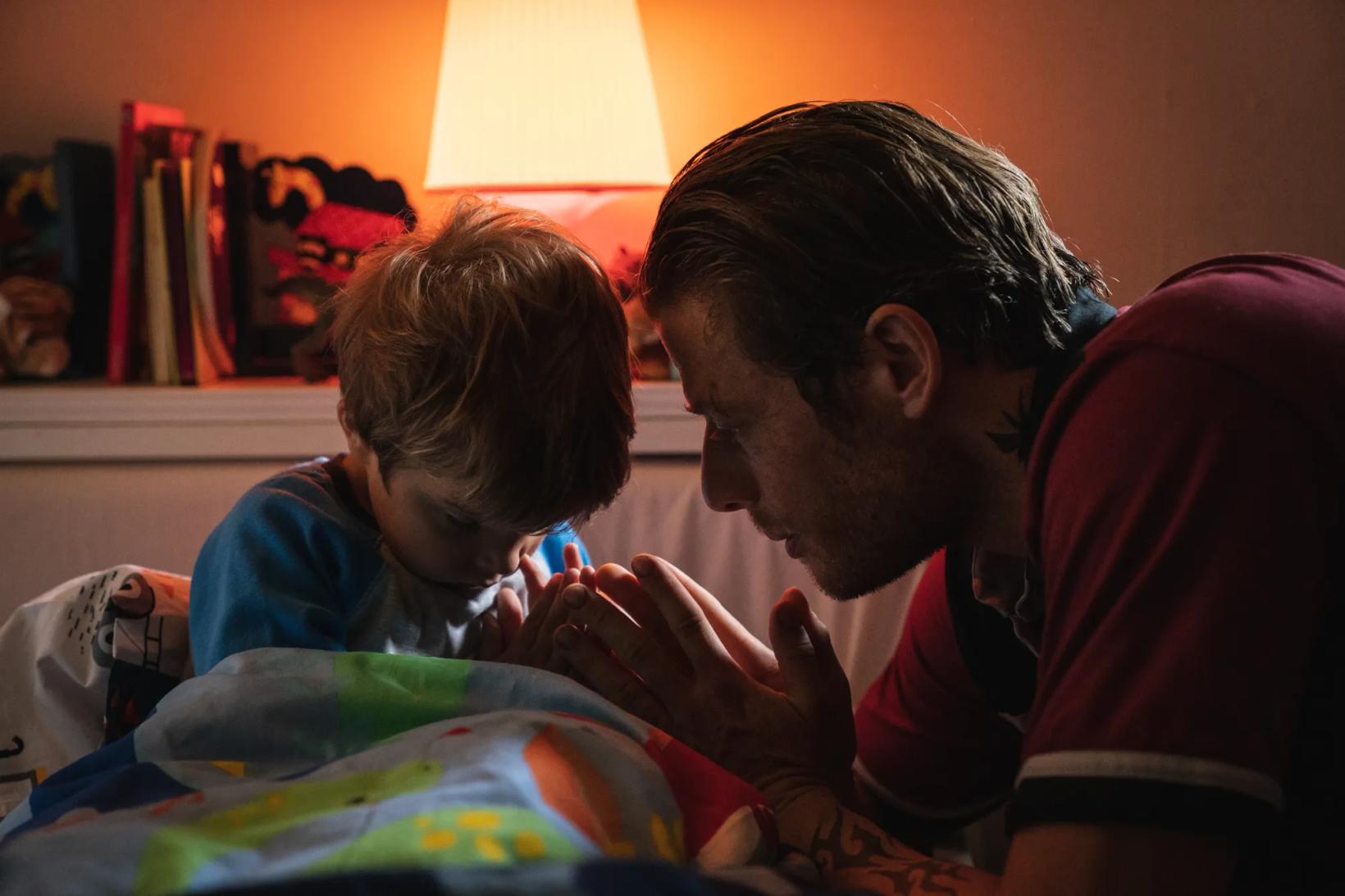 a man and a child looking at a book
