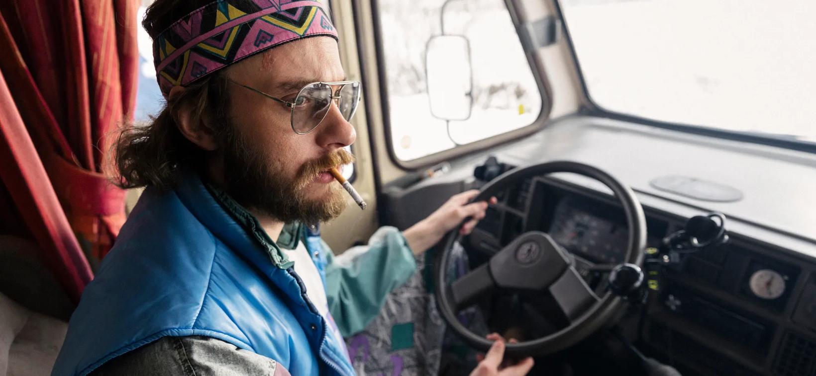 a man in a car smoking a cigar
