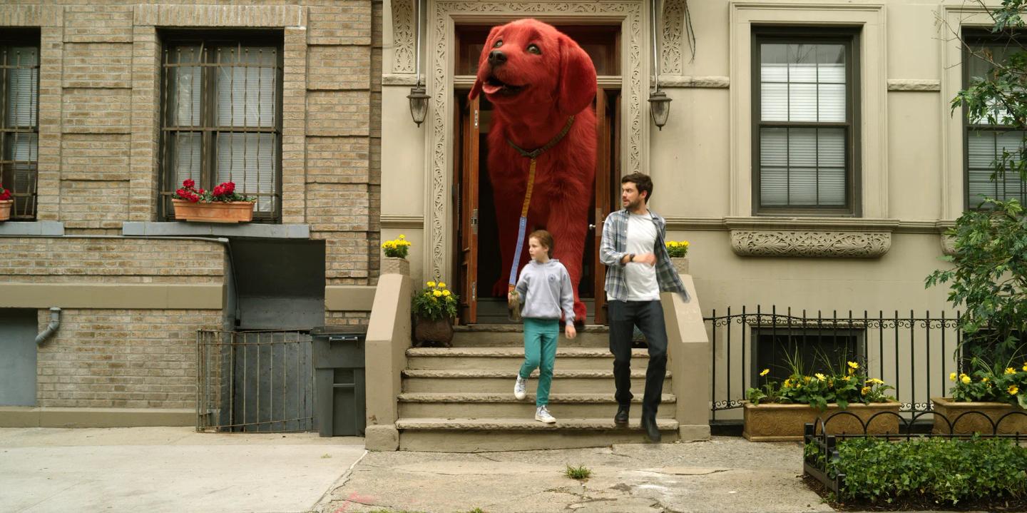 a man and a woman walking down stairs next to a statue of a horse