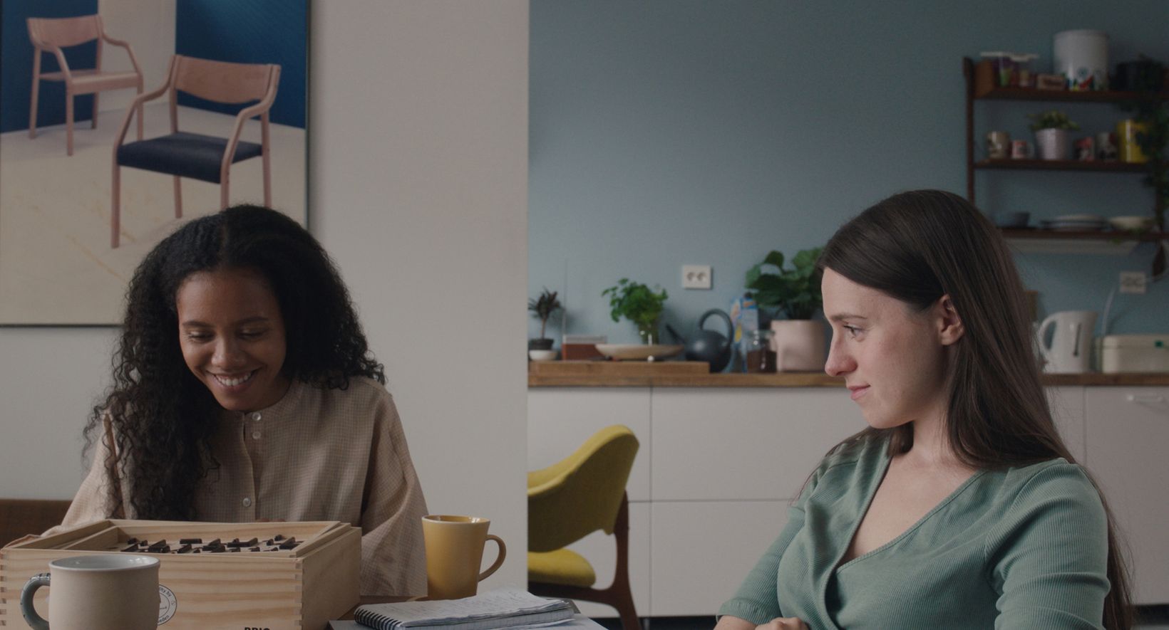 a woman sitting next to another woman