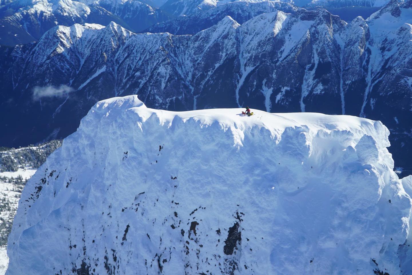 a person climbing a snowy mountain