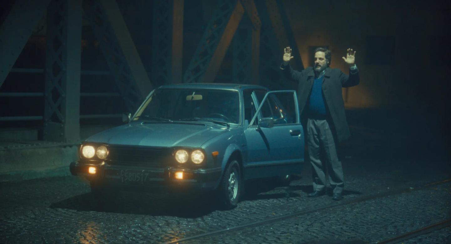 a man standing next to a car