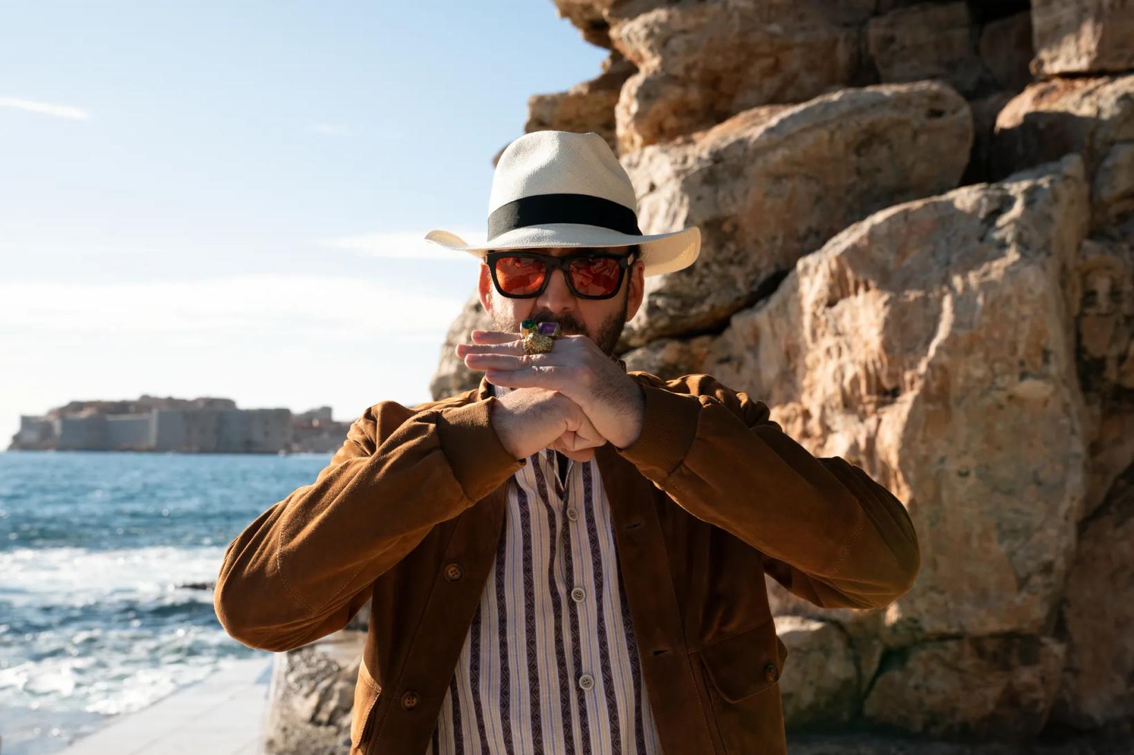 a man wearing a hat and sunglasses