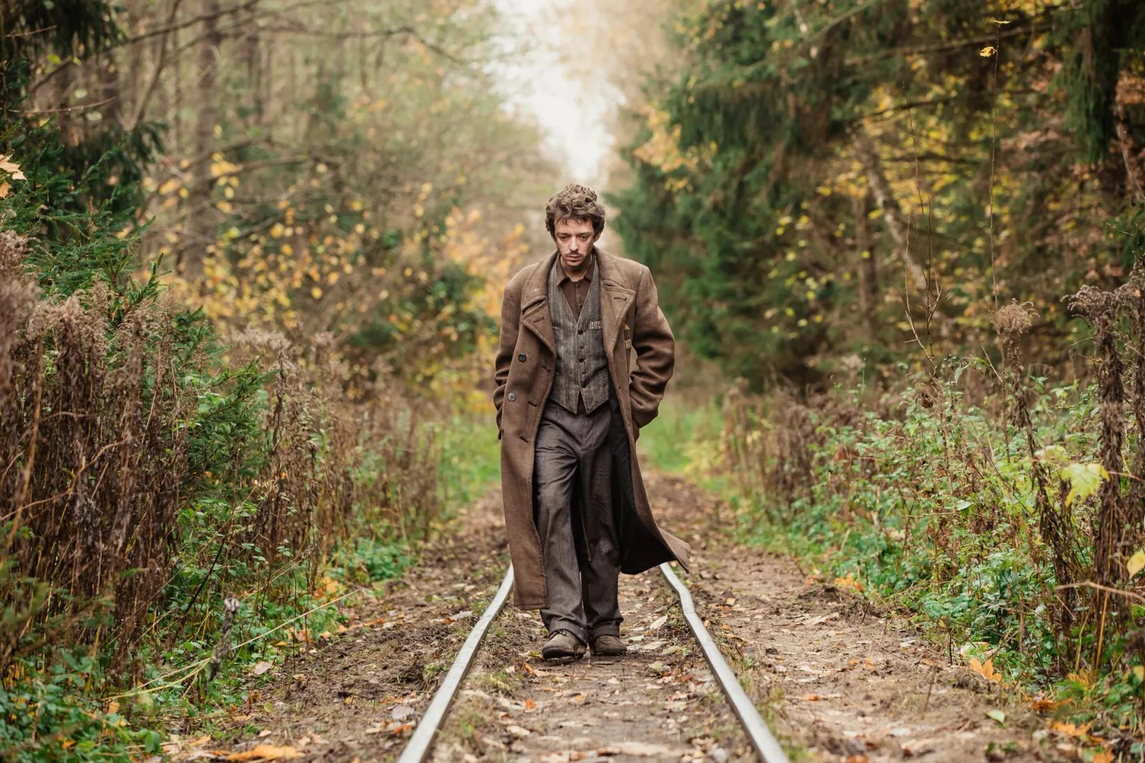 a person standing on a railroad track