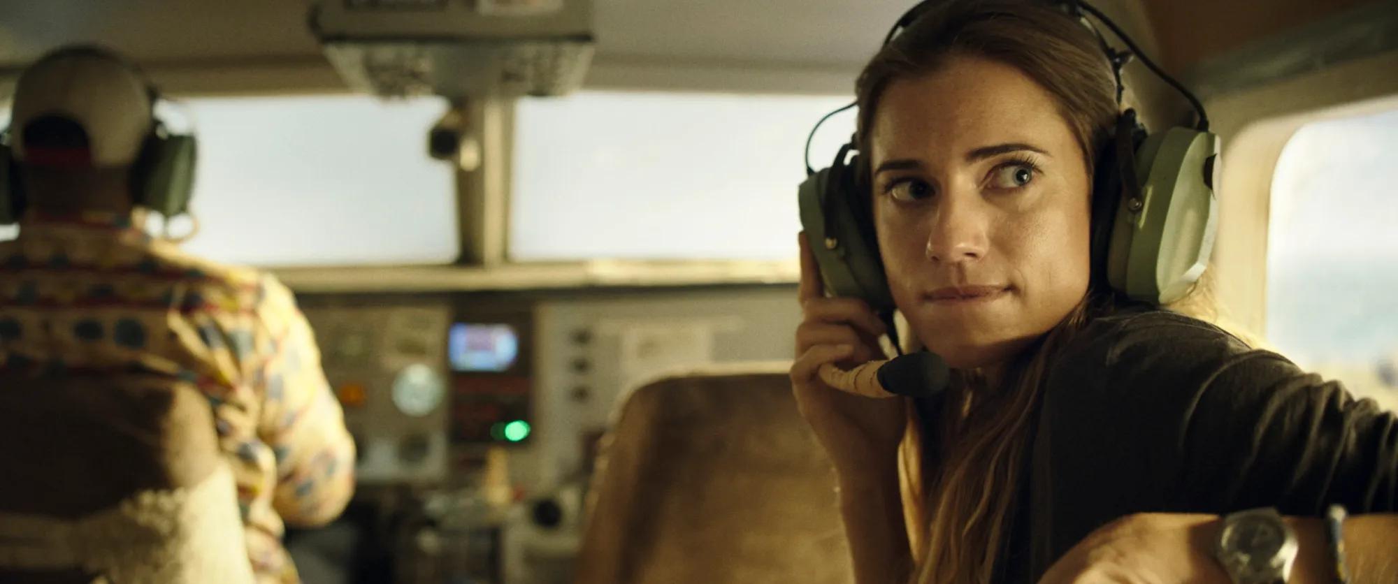 Allison Williams wearing headphones