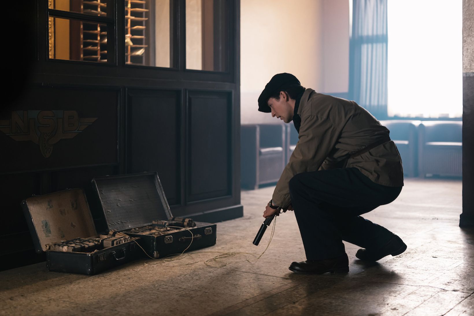 a man kneeling down next to a machine