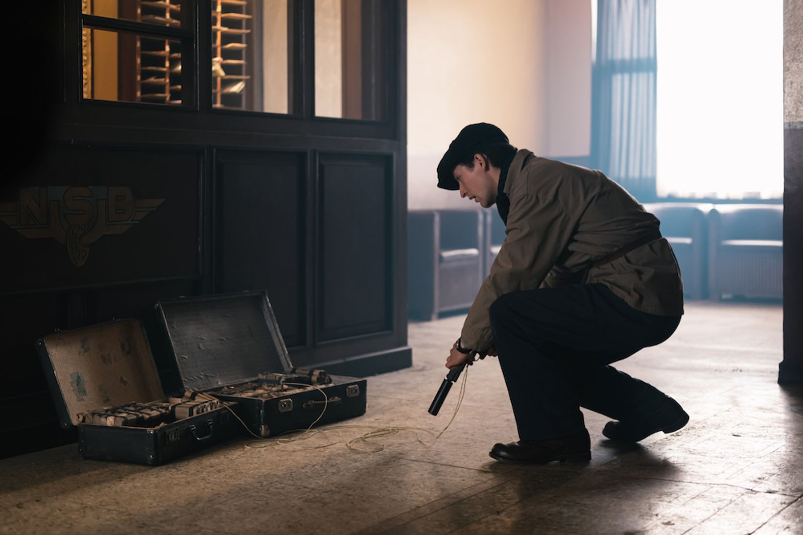 a man kneeling down next to a machine