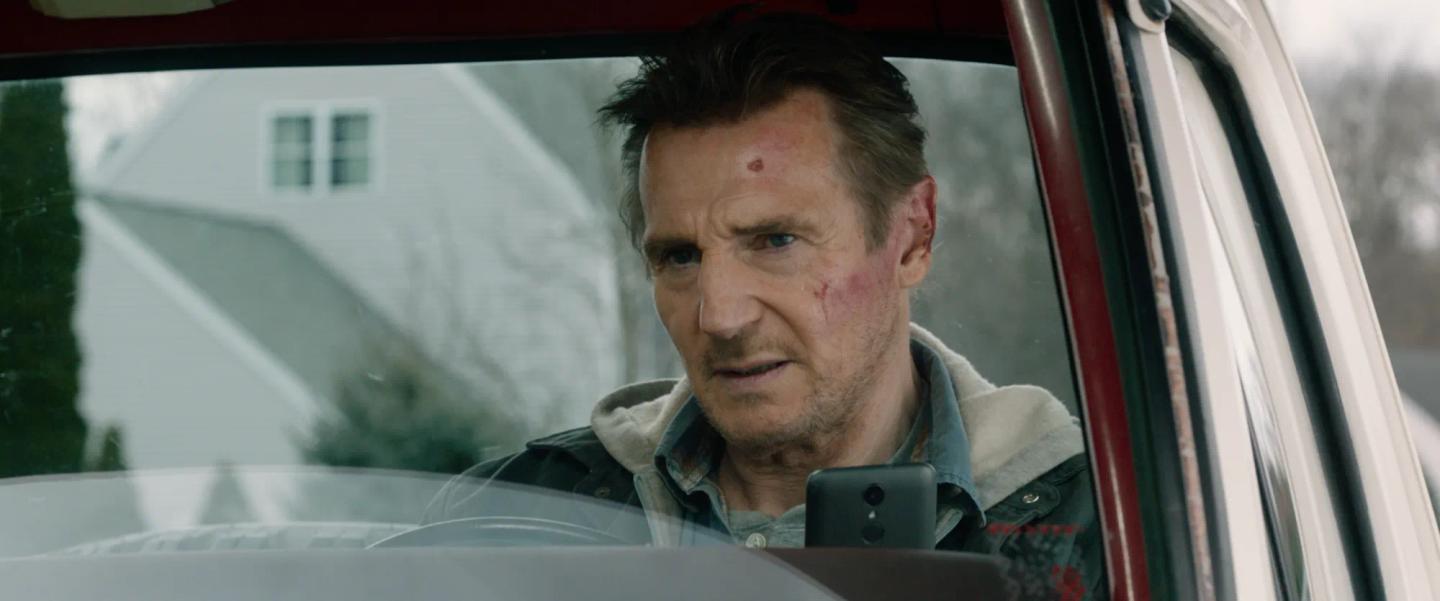 Liam Neeson in a car