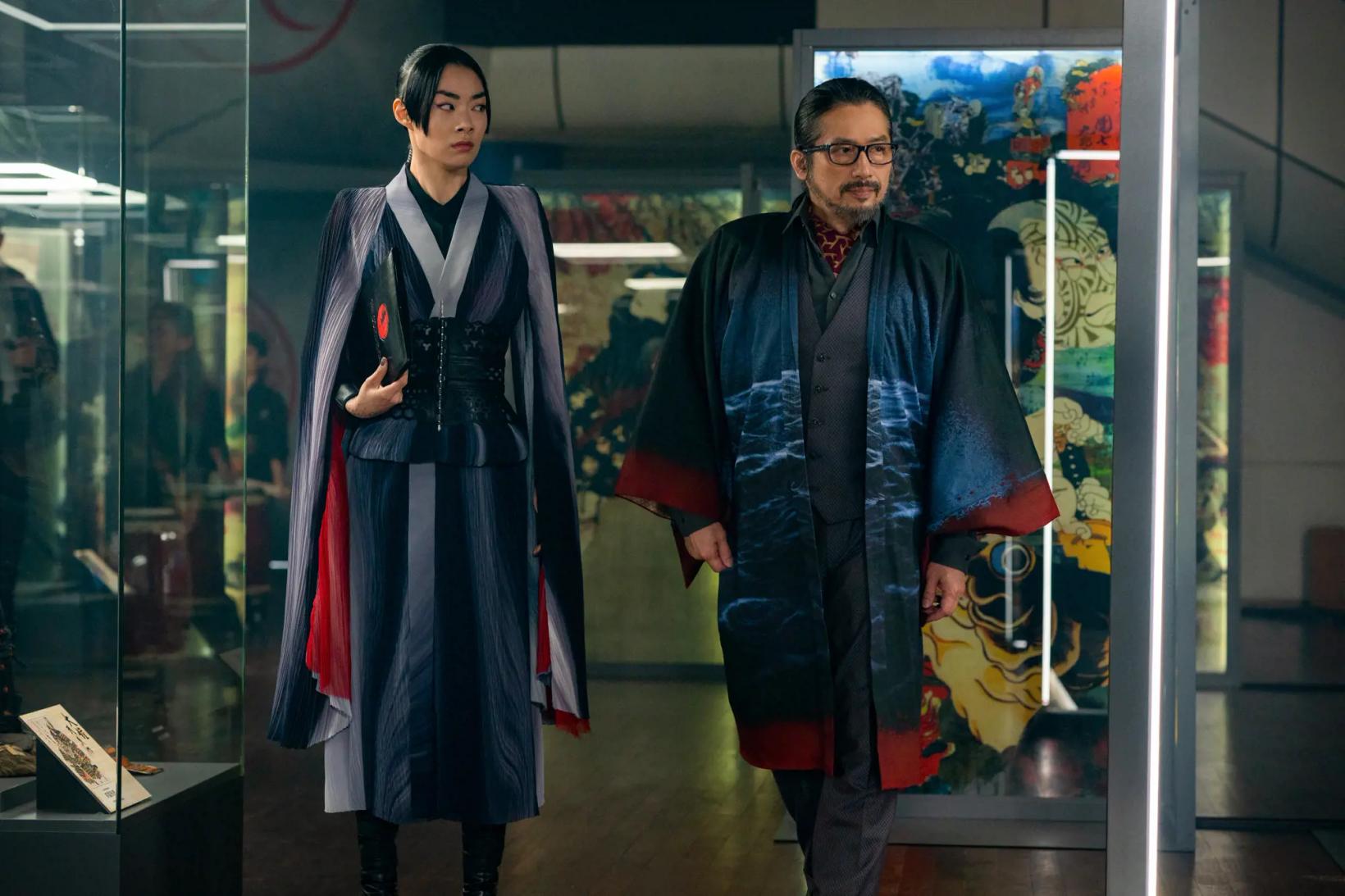 Hiroyuki Sanada et al. standing in front of a glass case