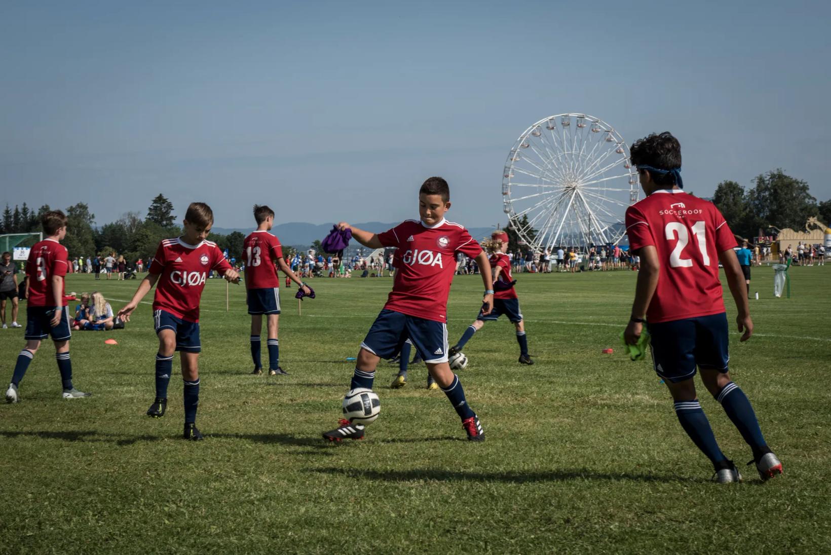 a group of kids playing football