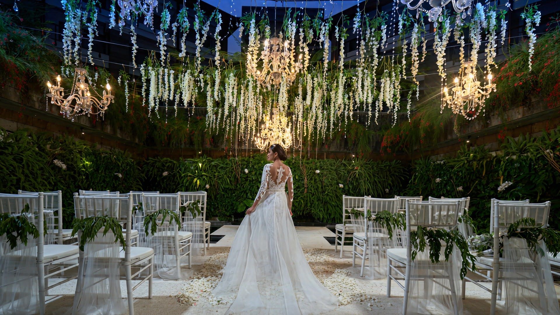 Brides standing in wedding hall with green floral decoration