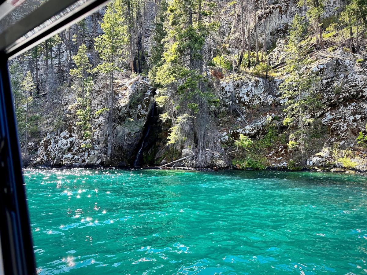 Turquoise water against a sheer granite cliff