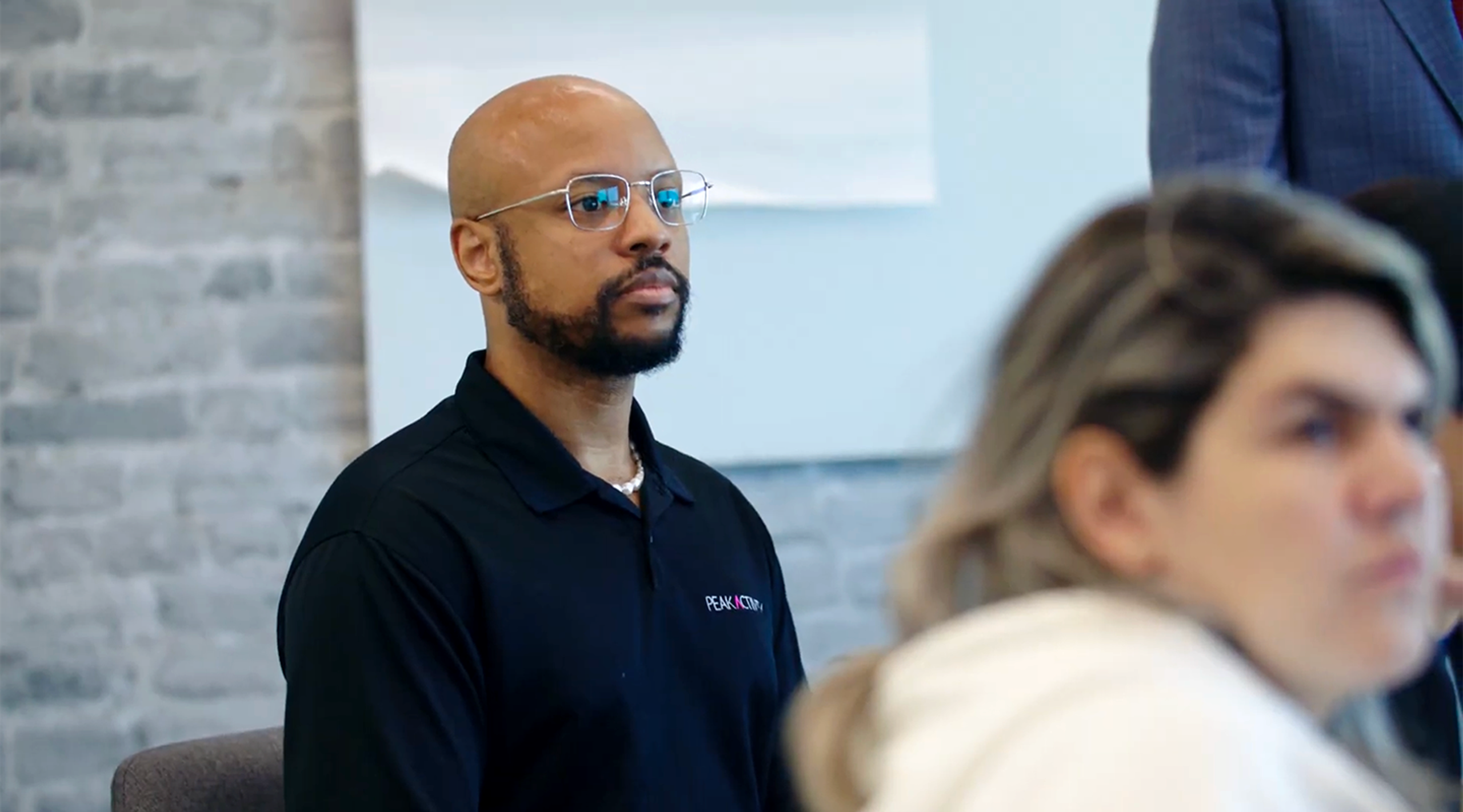 PeakActivity team member listening in a meeting