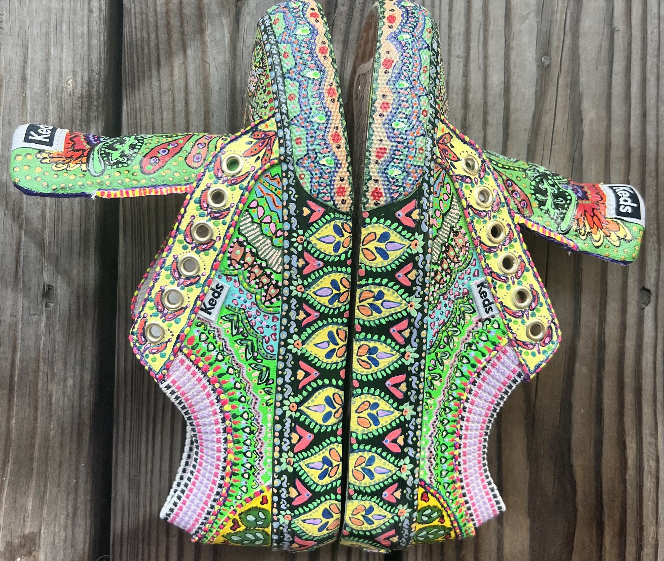 Side details of hand-painted Keds with green and pink patterns