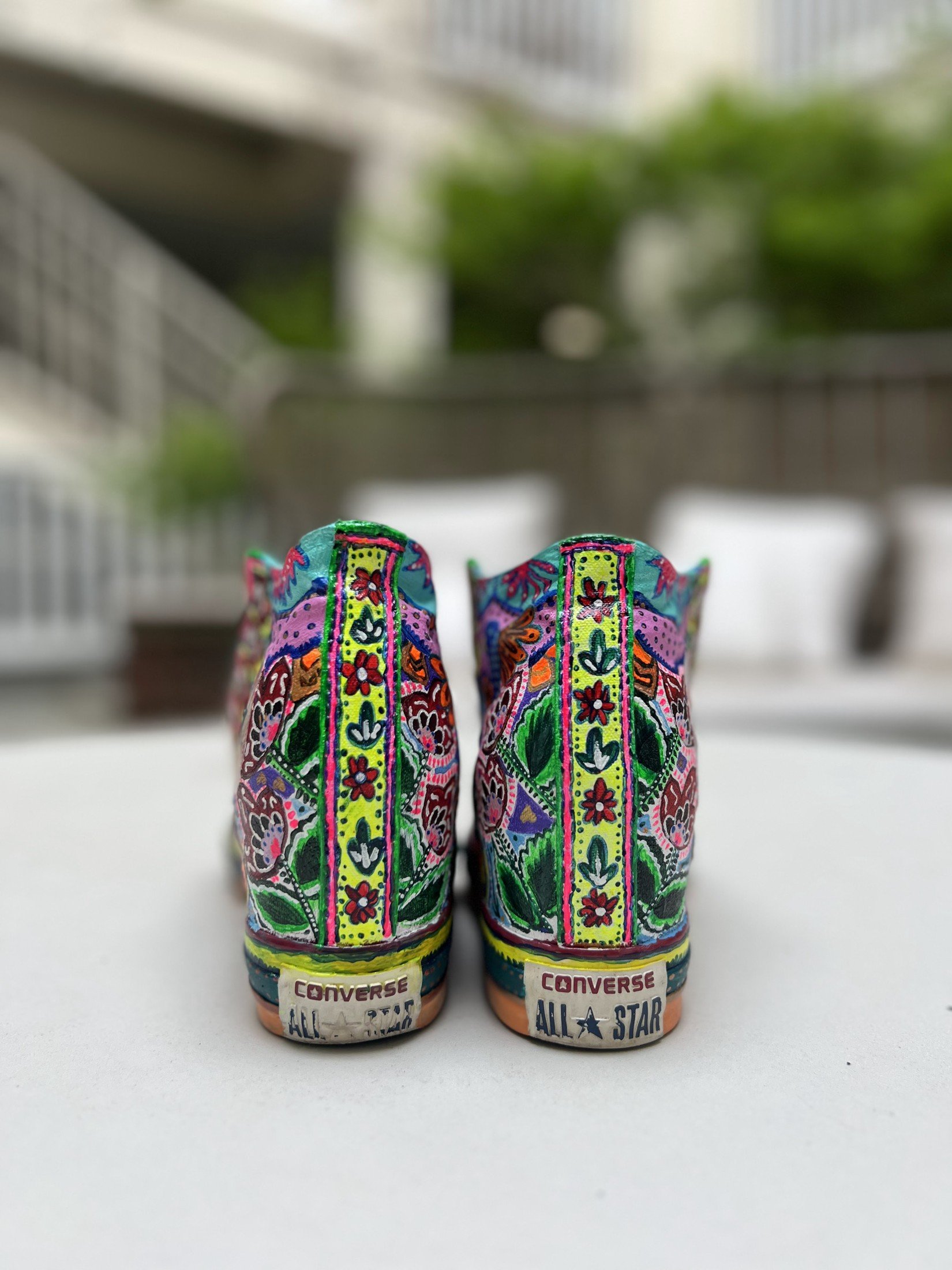 Back view of hand-painted high tops