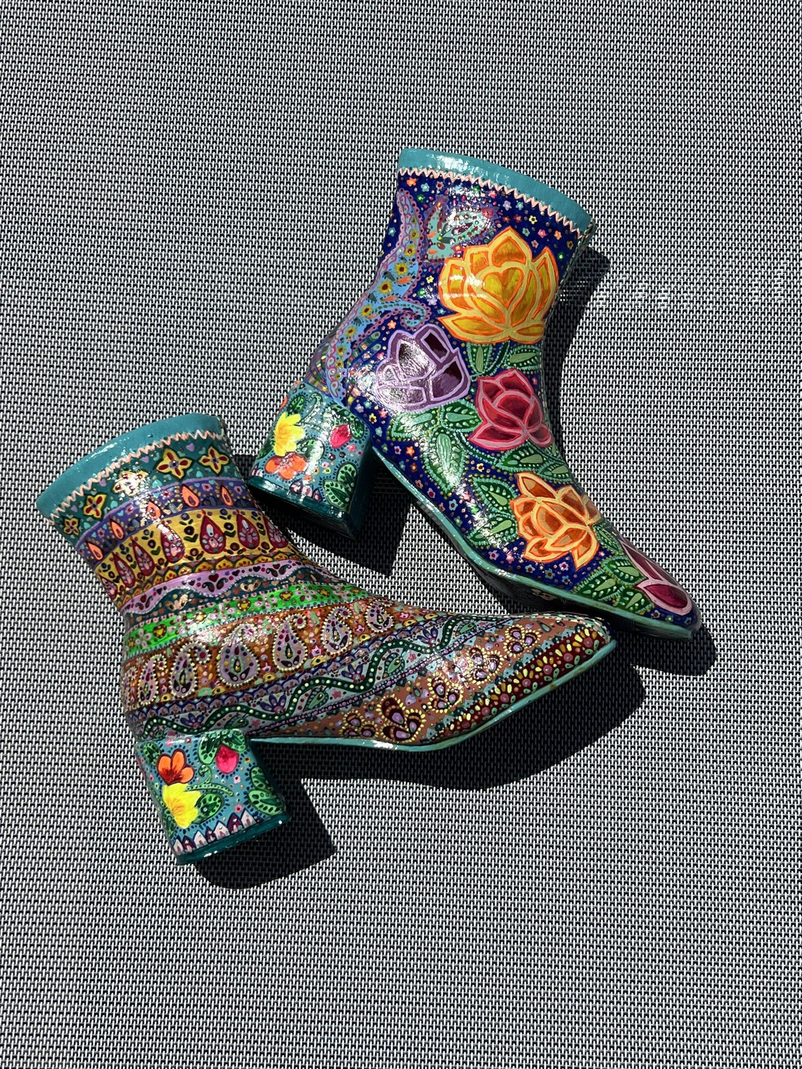 Side view of hand-painted boots with flowers and paisley patterns
