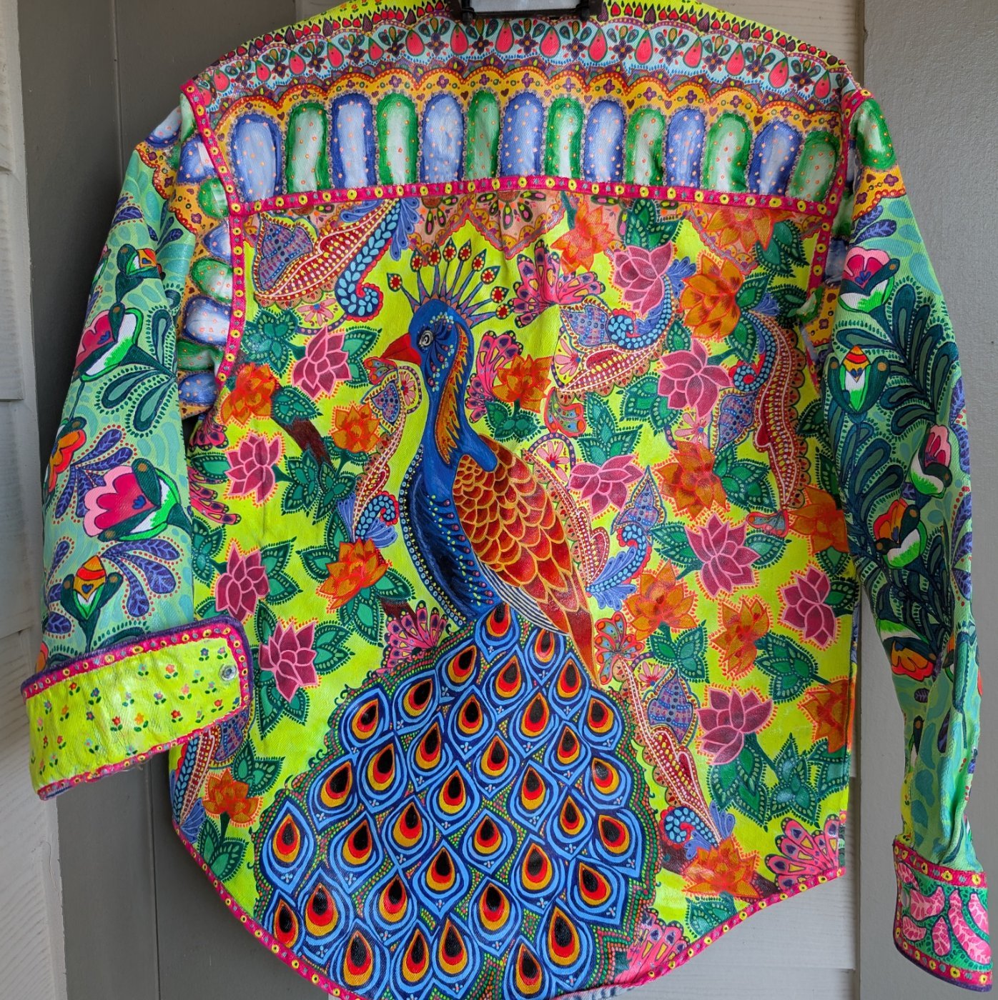 Back of the jacket with a large painted peacock