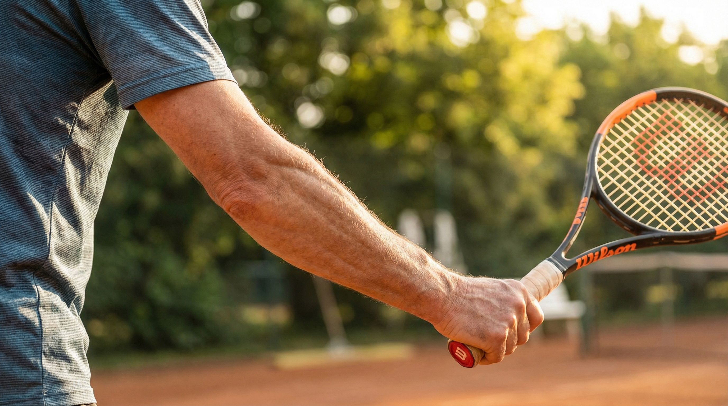 Active person gripping a tennis racquet pain-free after regenerative treatment