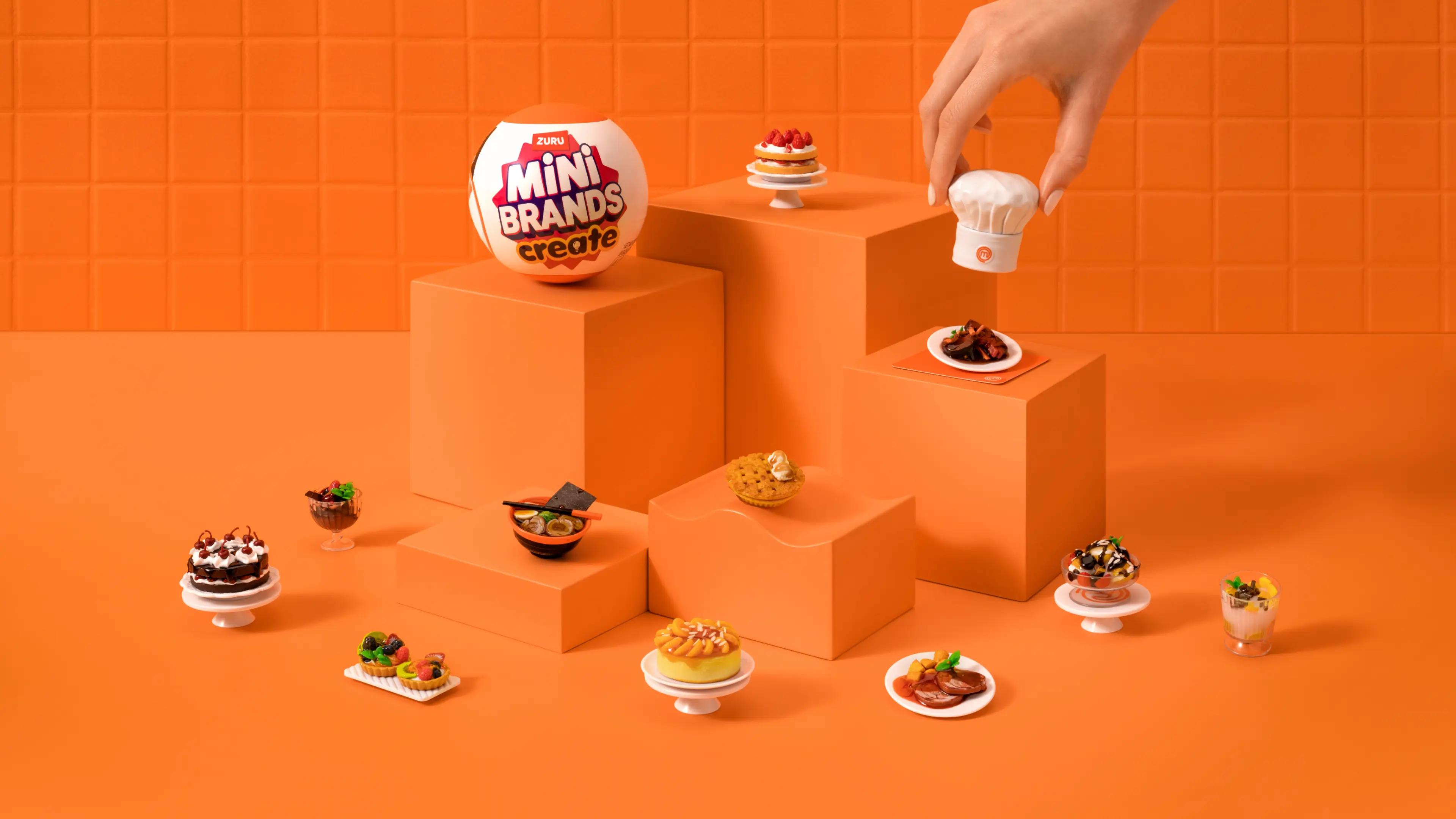 Creative display of ZURU Mini Brands MasterChef series miniatures with various miniature foods artistically arranged on different levels of orange blocks, showcasing the collectible nature and culinary theme.
