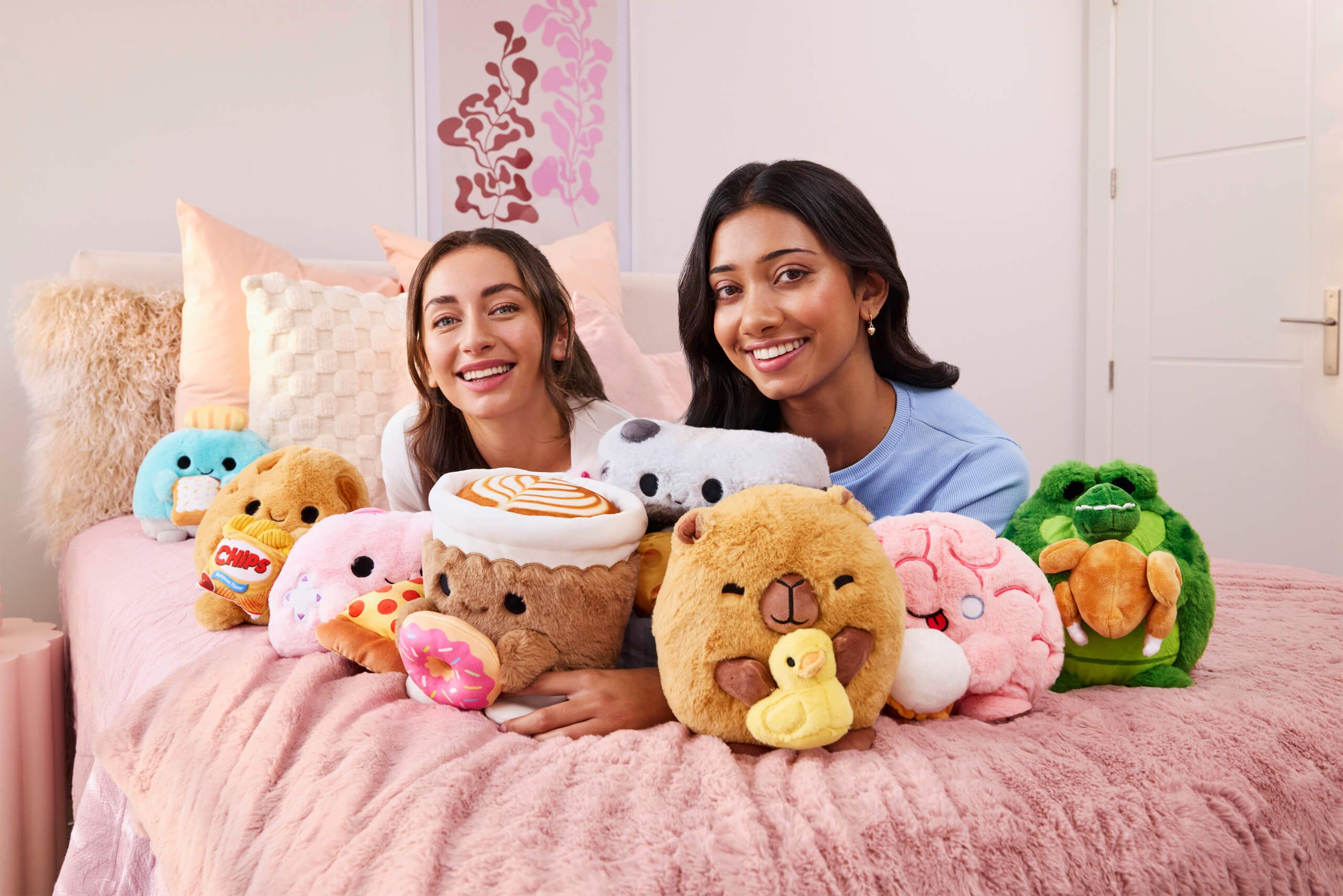 Girl laying on pile of snackles plushies | ZURU Toys