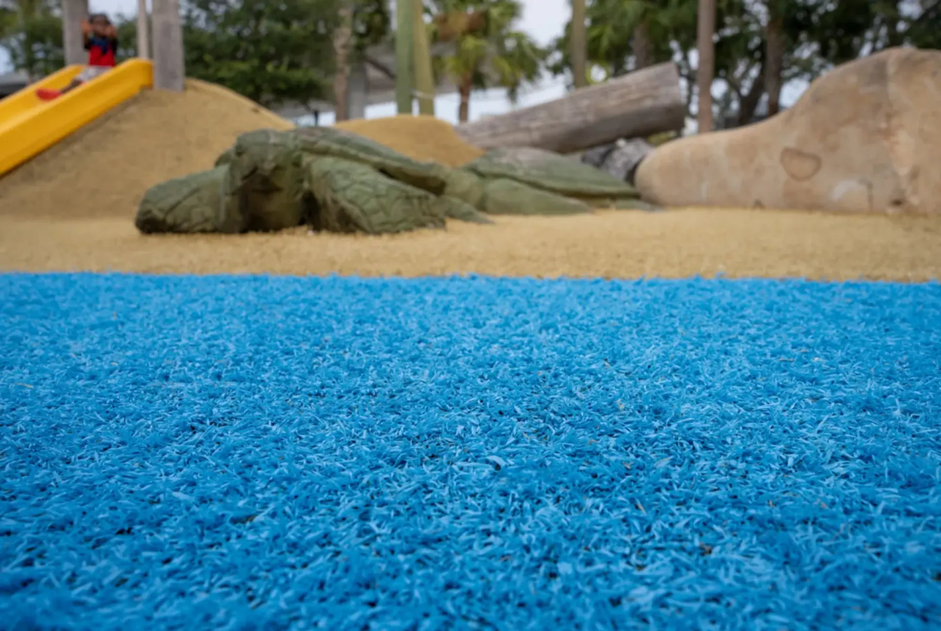 Daycare playground with a numbered hopscotch snake on artificial grass
