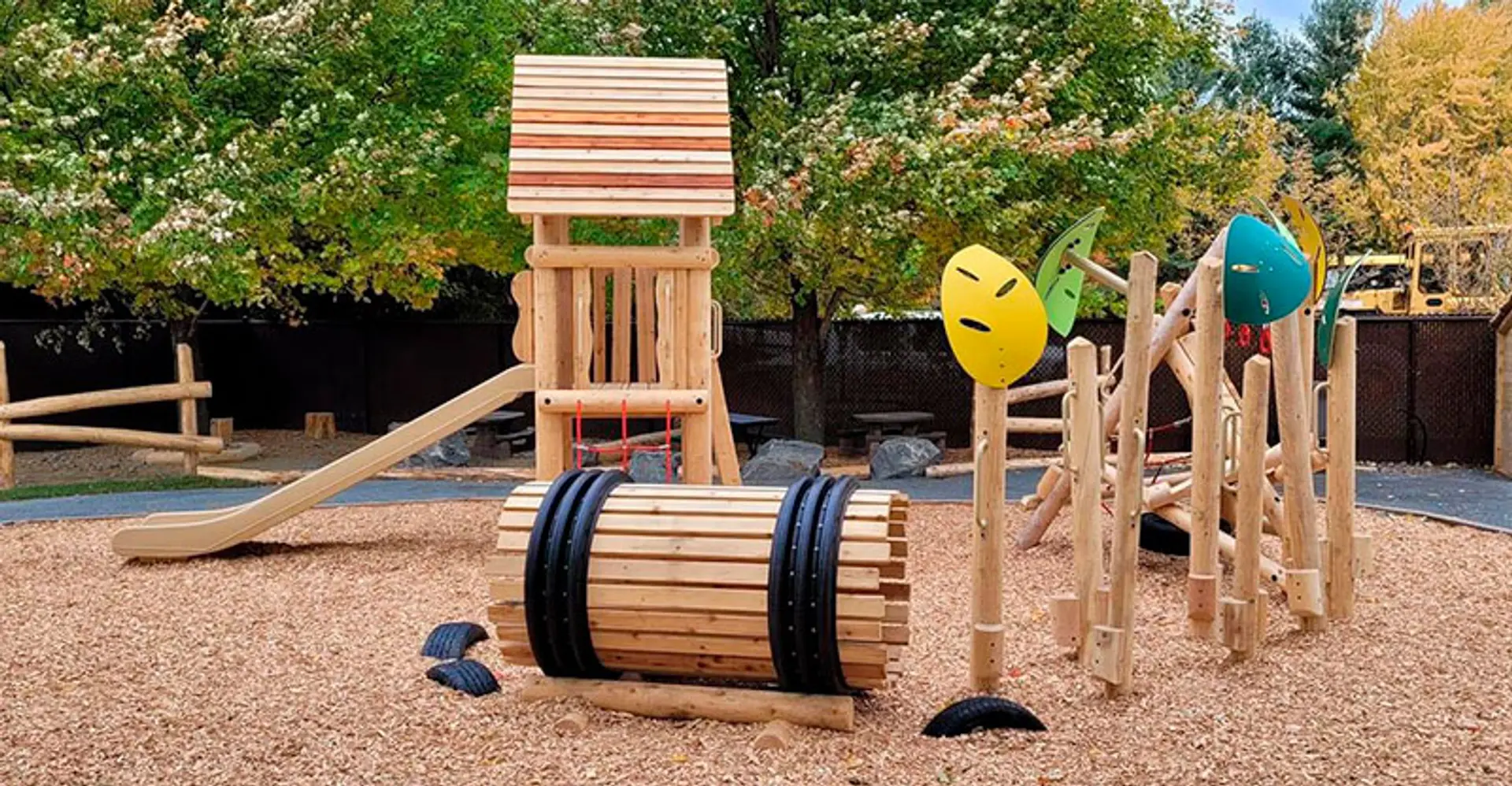Custom wooden play structure in a designed landscape