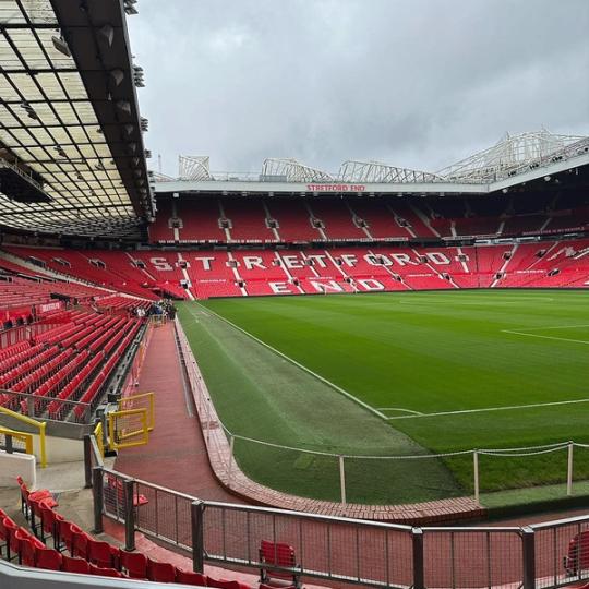 En empty Old Trafford on a cloudy day overlooking Stretford End