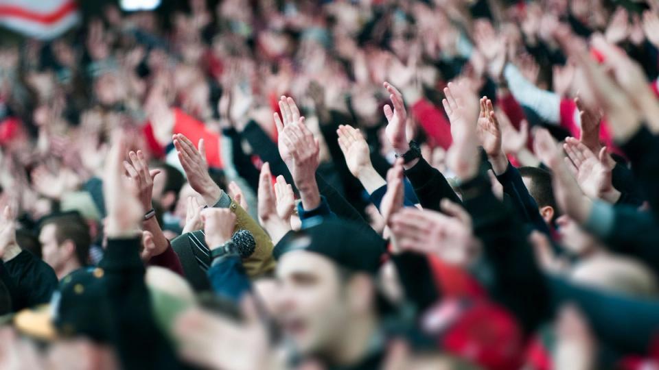 Football fans cheering for their team