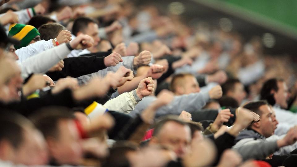 Football fans cheering for their team