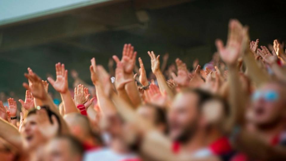 Football fans cheering for their team
