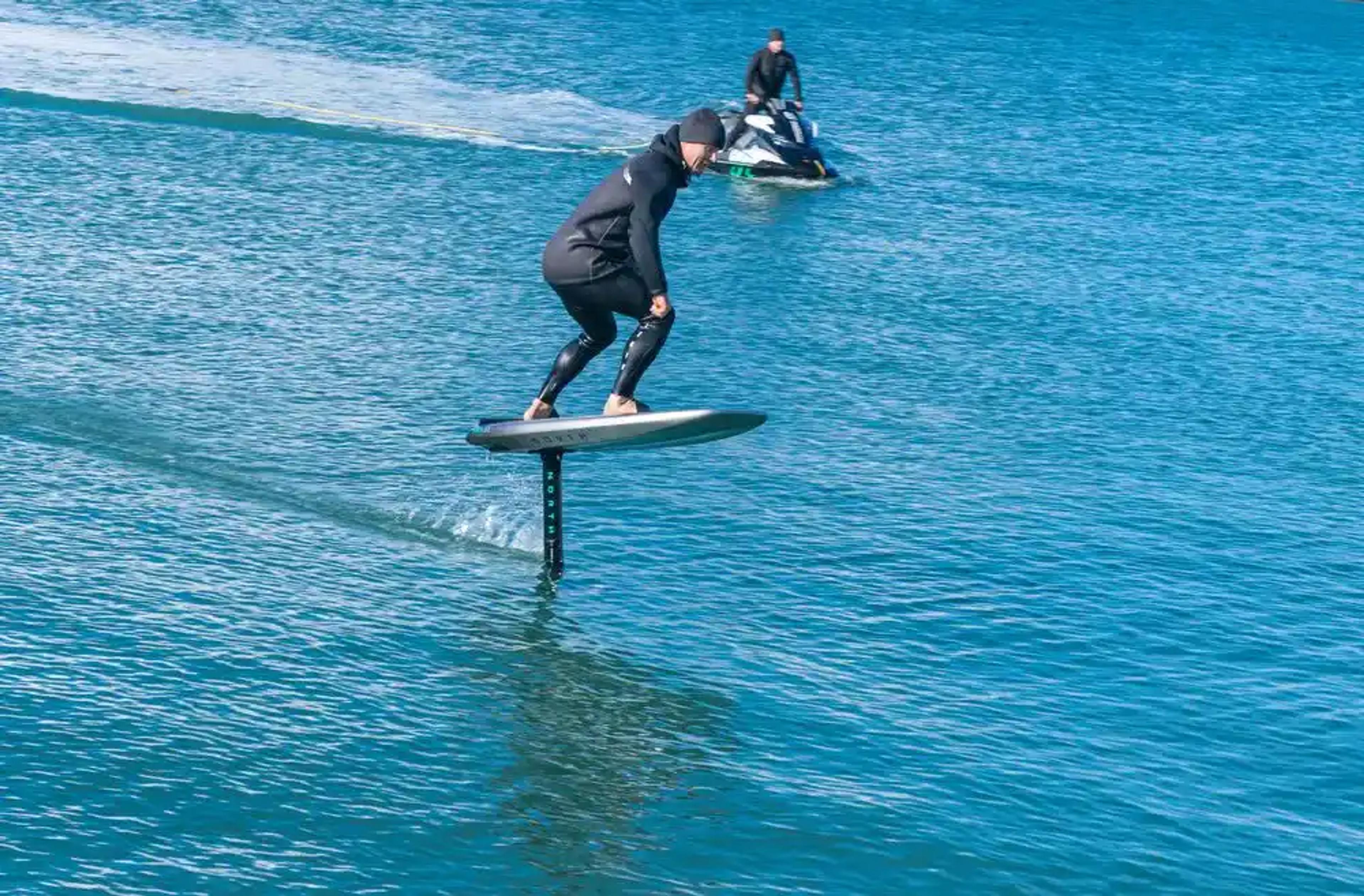 Man on electric foilboard hydrofoil surfboard