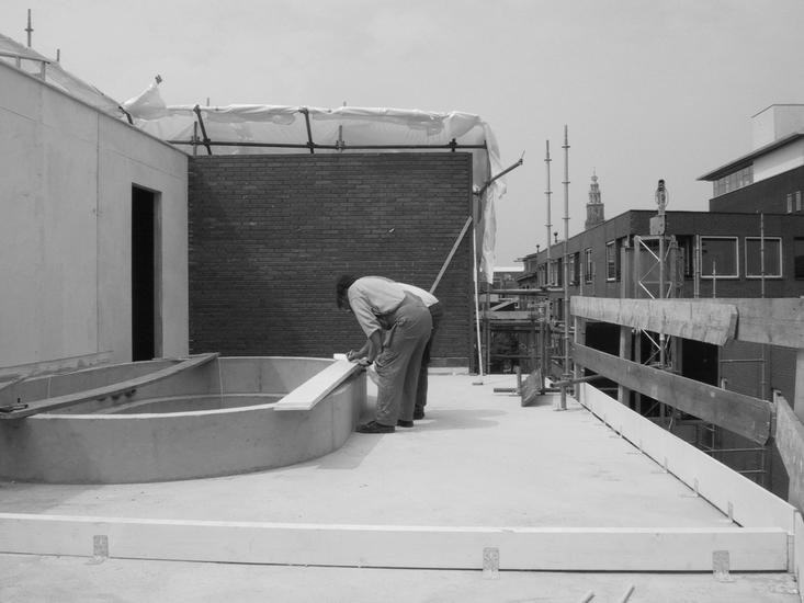 black and white photo of the building of the swimming pool on the third floor