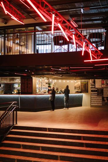 Photo bar area, neon art and part of the central staircase