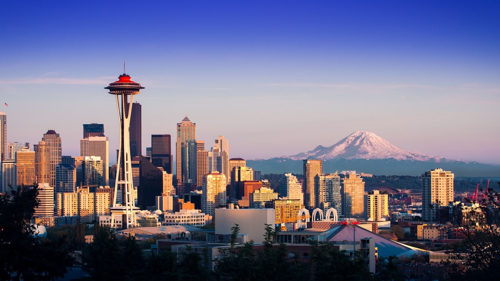 Seattle skyline at dusk with Mount Rainier in the distance