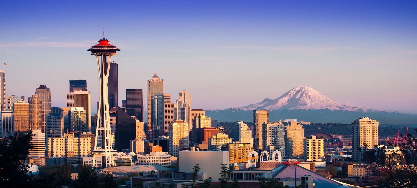 Seattle skyline at dusk with Mount Rainier in the distance